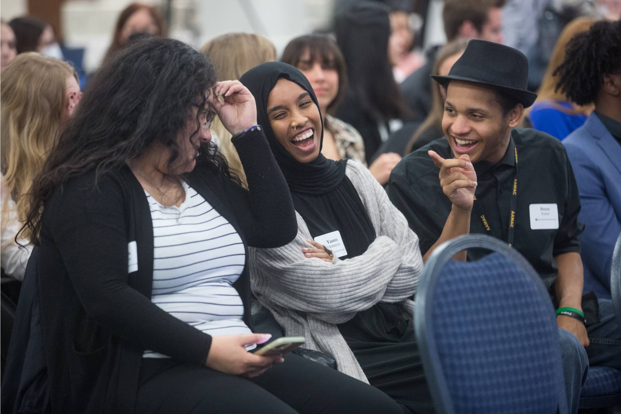 students laughing in audience at event